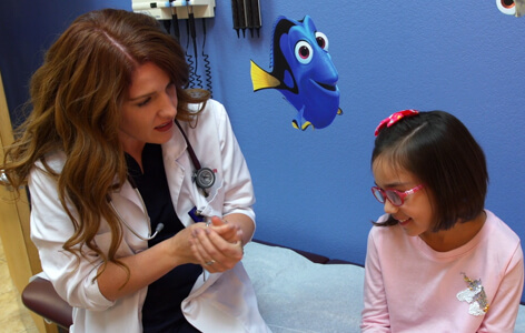 woman doctor at banner urgent care talking to a young girl