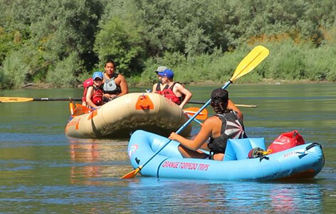 two river raft boats with people inside