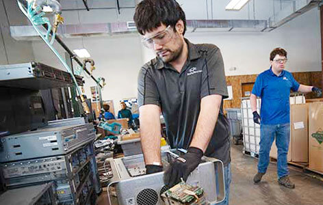 Young man recycling computer parts